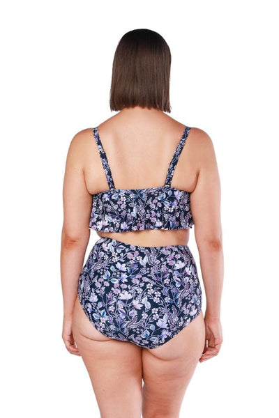 Back of model wearing one tiered frill bikini top with adjustable straps in navy floral print