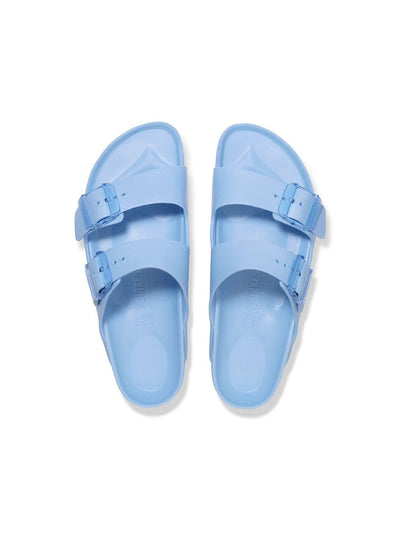 Pair of light blue sandals on a white background