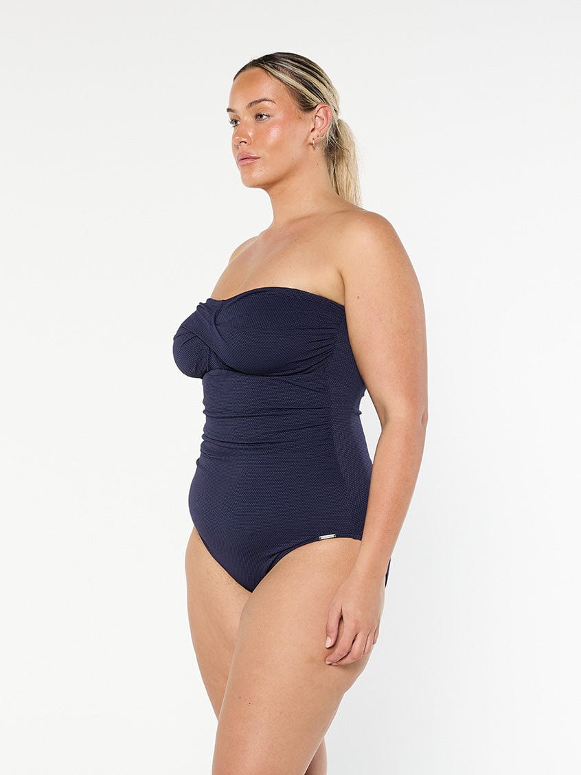 model showing side of navy bandeau one piece