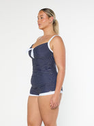 model showing side of navy polka dot boyleg swimsuit