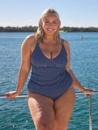 model wearing navy and white dots swing tankini