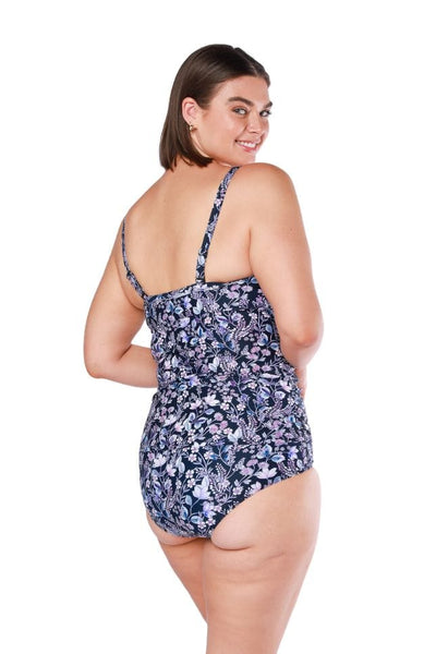 Back of model wearing floral tankini swim top with adjustable straps in purple tones
