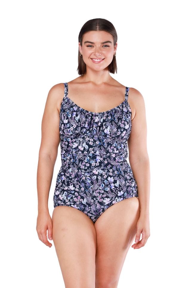 Brunette model wearing purple floral underwire tankini top for curvy women