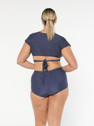 model showing back of navy and white dots swim bikini pant