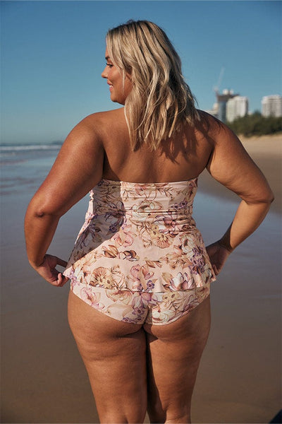 Blonde model showing back of pink floral layered tankini swim top