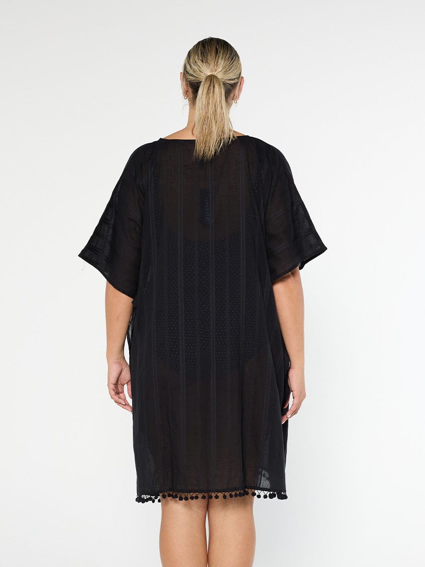 model showing back of black cotton kaftan with pom poms