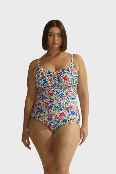 Curve women wearing bright floral underwire one piece with ruching tummy control