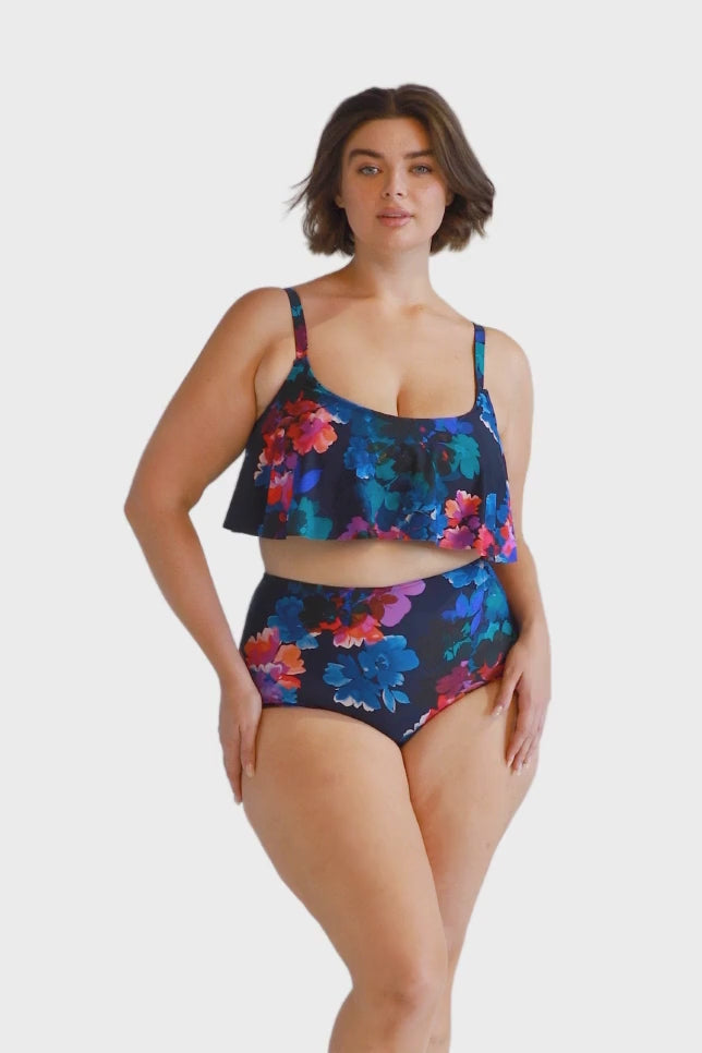 Brunette model wears navy floral high waisted bikini bottoms