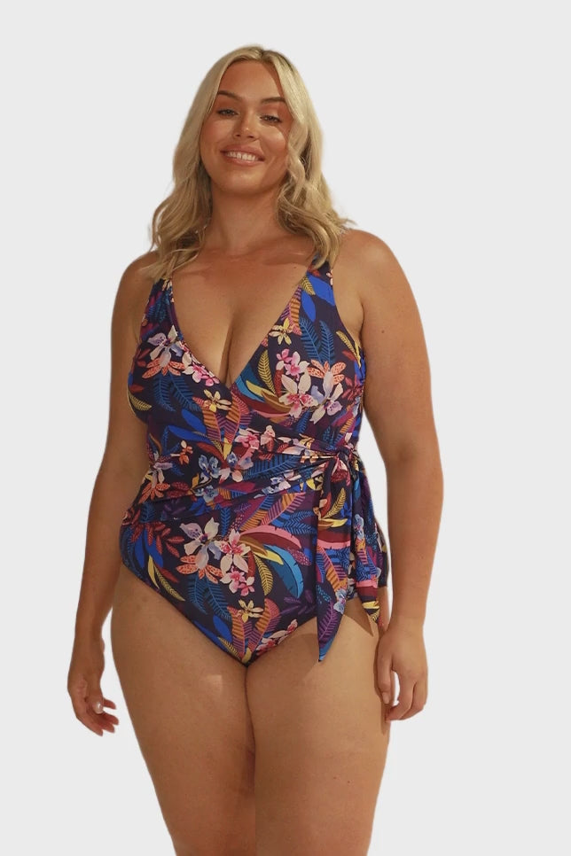 Video of model in studio wearing crossover one piece in floral print