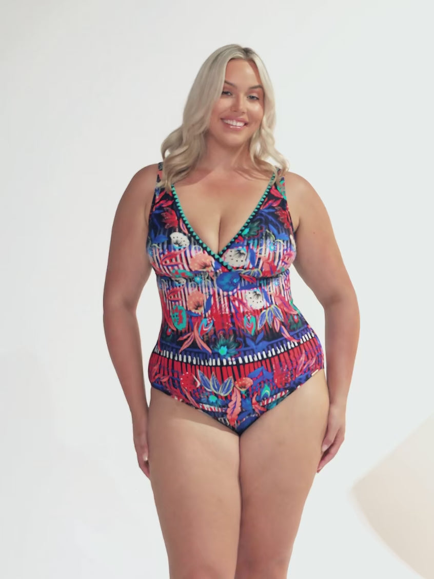 Video of model in studio wearing curve one piece with multi coloured print and embroidery trim