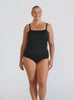 Blonde model in studio wearing a flouncy bandeau tankini top in black textured fabric
