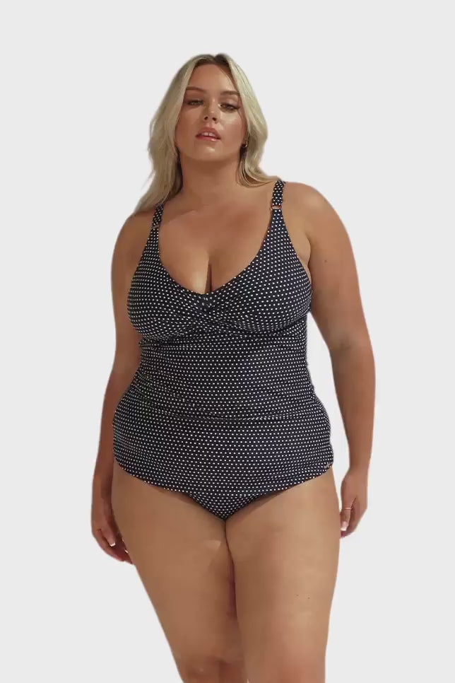 Video of model in studio wearing v neck style swim tankini top in navy and white Polkadot for plus size women