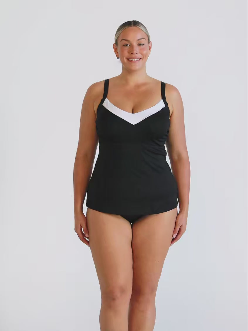 Blonde model in studio wearing underwire tankini top with white trim neckline
