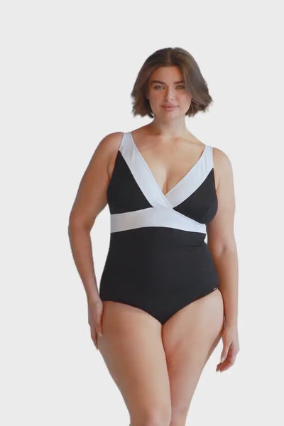 Curve model wears flattering low v neck black one piece with white trim