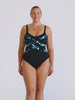blonde model in studio wearing a criss cross one piece with adjustable straps