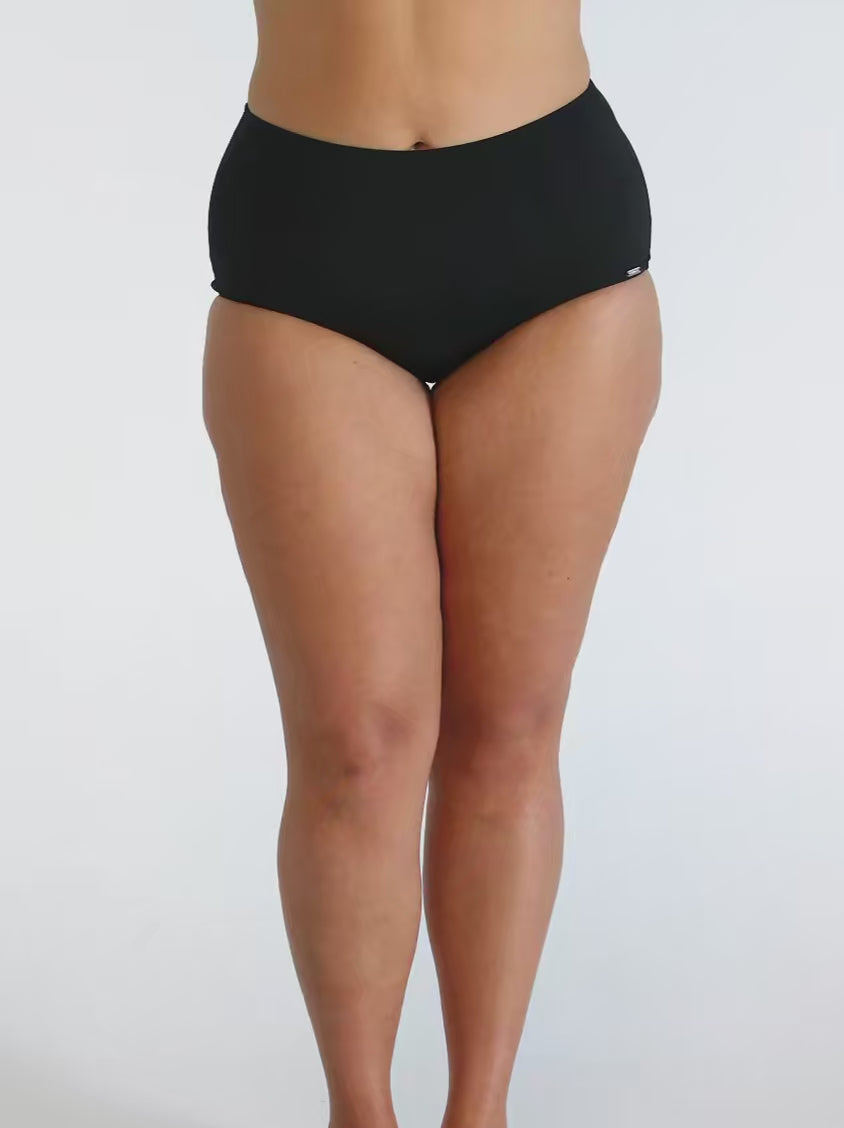 Curve woman in studio wearing chlorine resistant high waisted pant