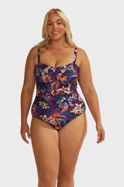Video of model in studio wearing strapless bandeau one piece with removable straps and adjustable straps