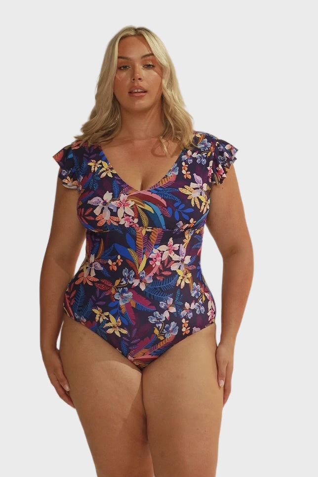 Video of model in studio wearing a frill sleeve one piece with scoop back