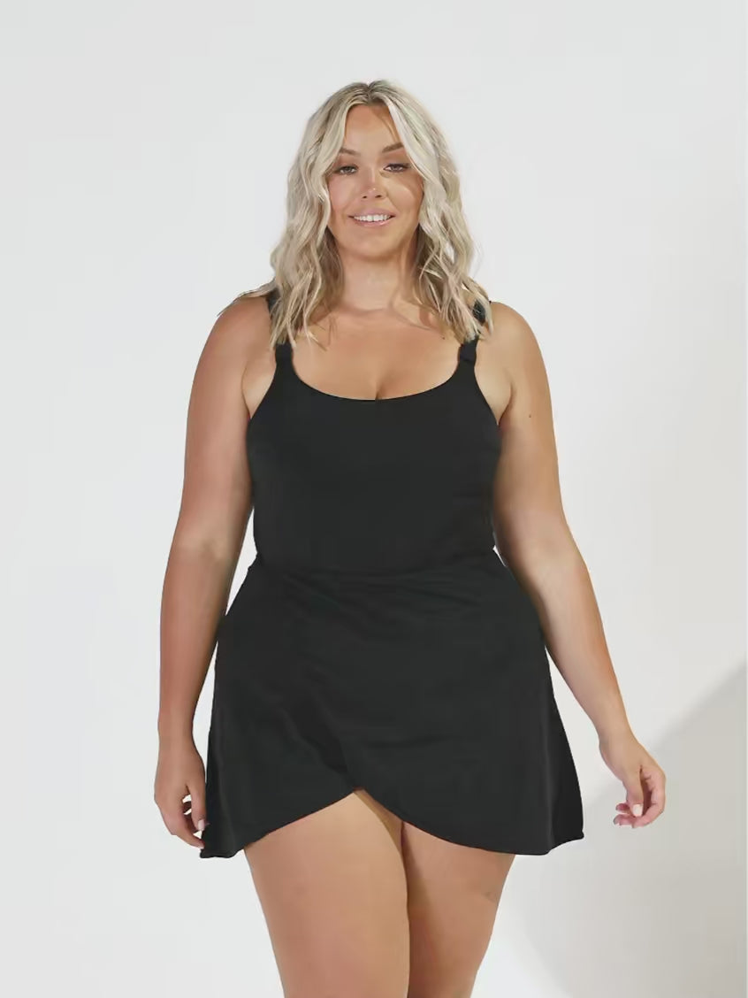 Model in studio wearing a crossover wrap skirt in black