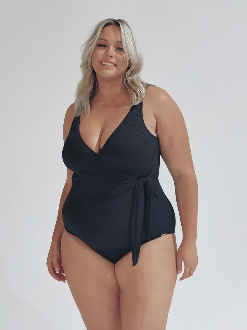 model wearing navy textured waist tie one piece swimsuit