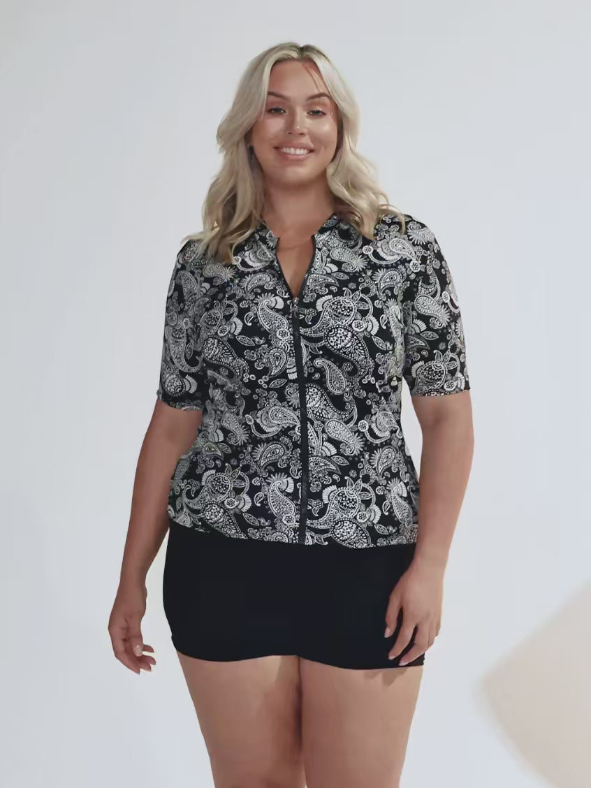 Blonde woman wearing a paisley printed short sleeve rash vest in chlorine resistant