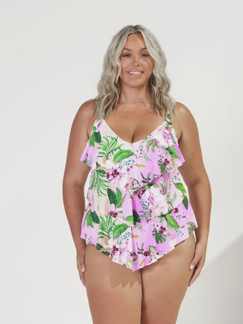 Blonde woman in studio wearing tiered tankini top in floral pink colour