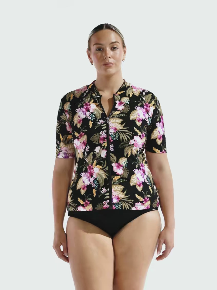 Blonde model in studio wearing floral chlorine resistant rash vest
