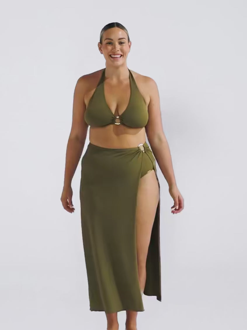 Blonde model in studio wearing a long maxi khaki skirt in a honey comb texture fabric