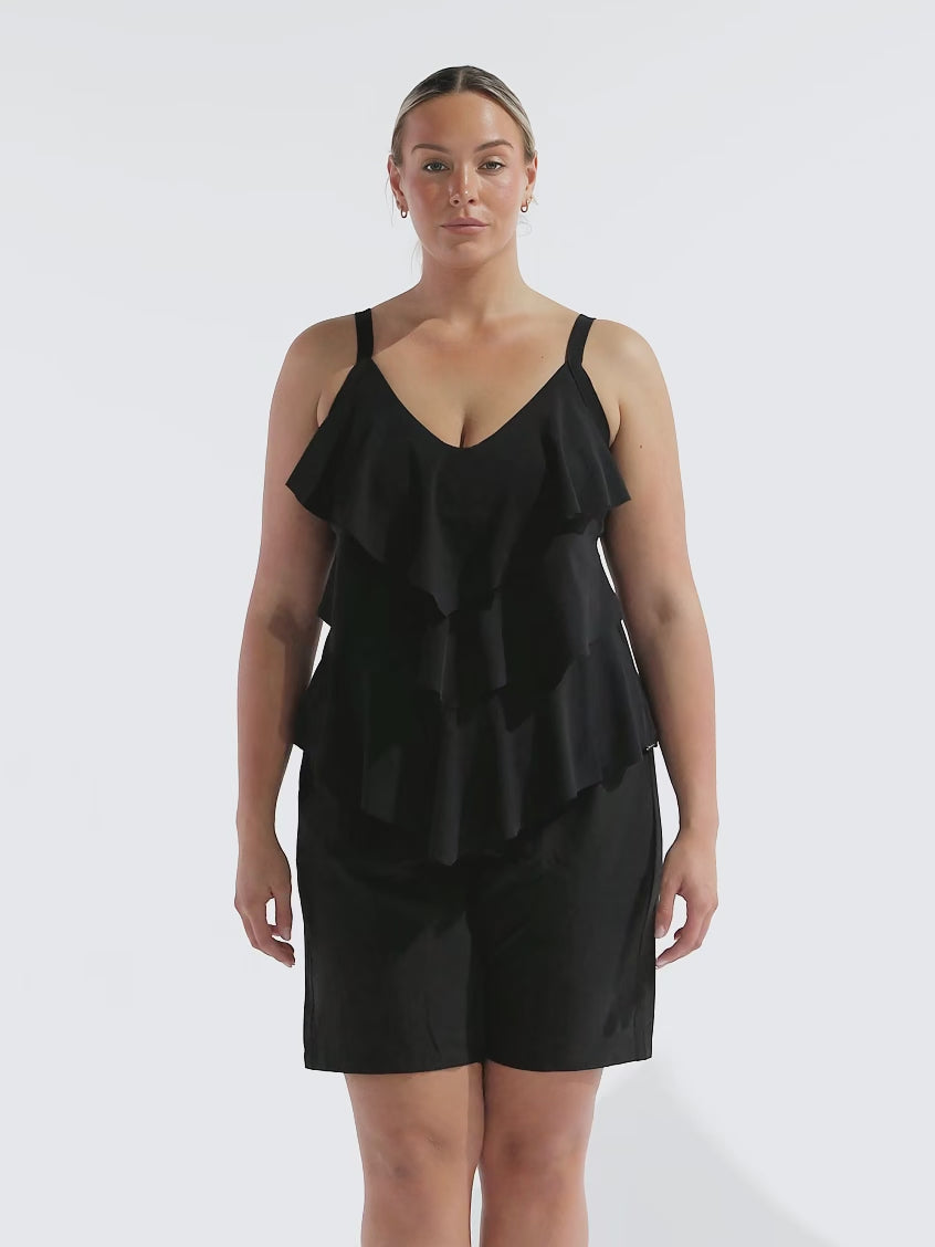 model wearing black board shorts with tiered tankini