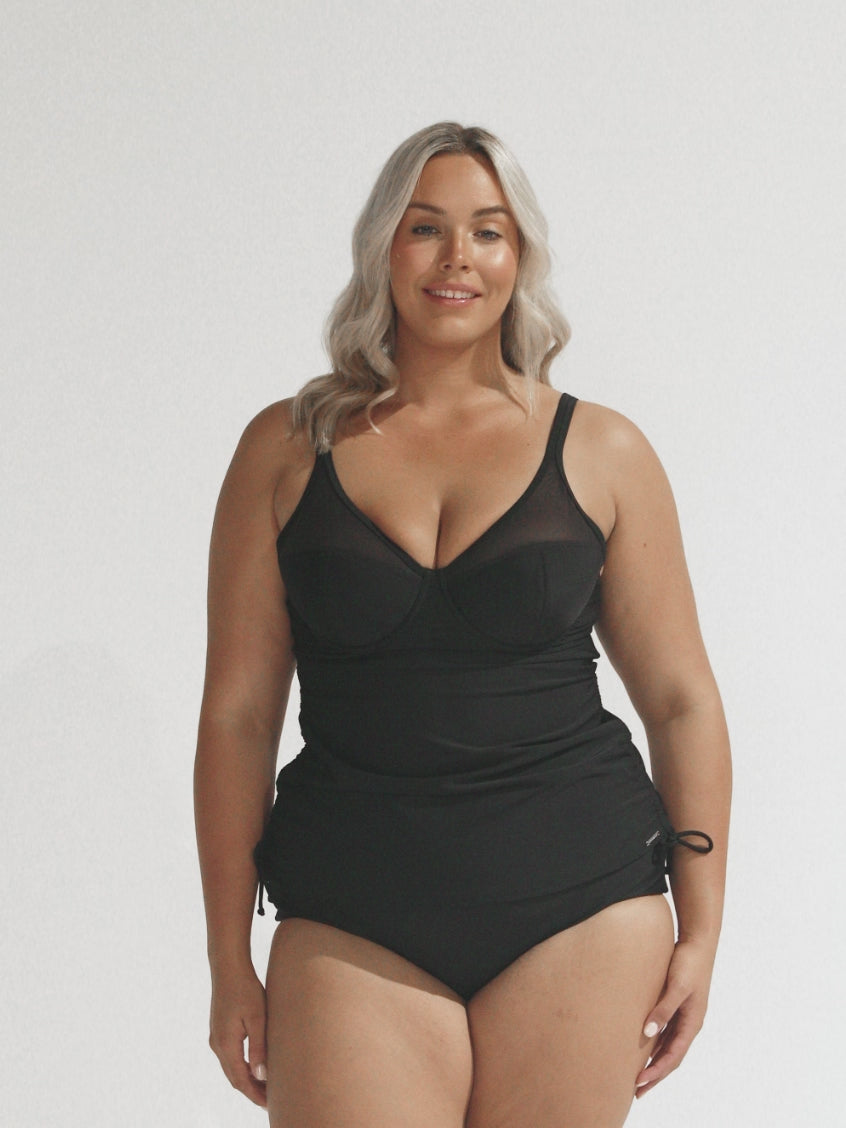 Blonde curve model in studio wearing ruched tankini top with mesh detail