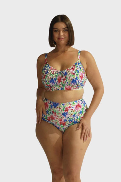 Video of brunette model in studio wearing flattering high waisted bright coloured floral swim pant Australia