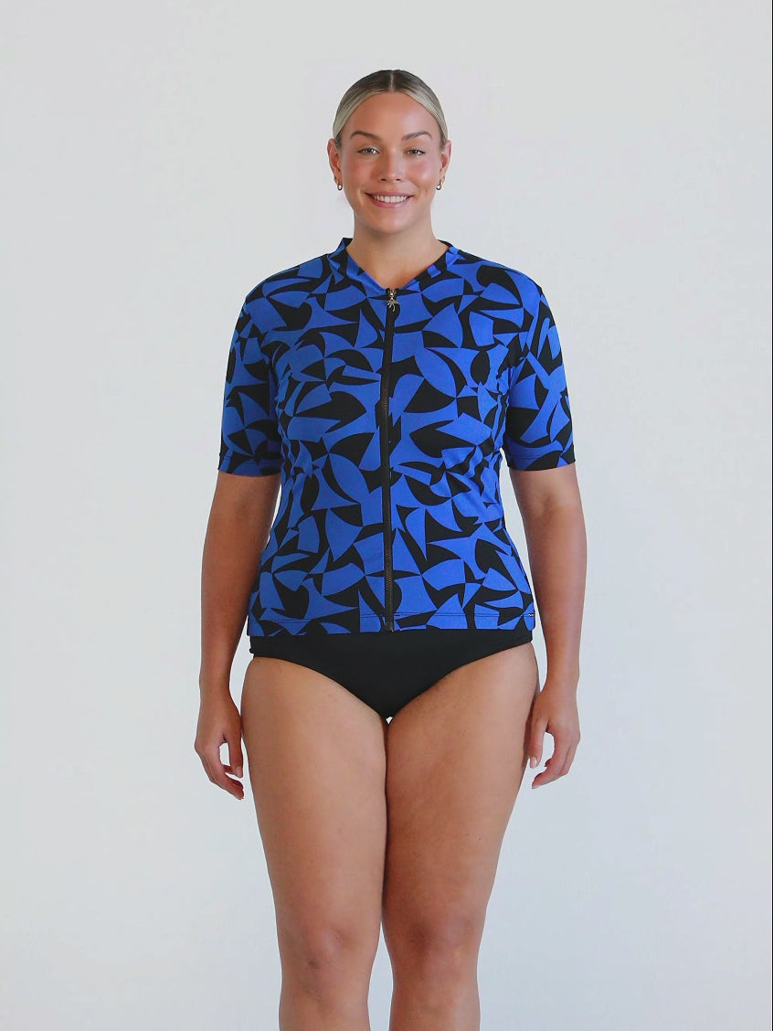 Blonde model in studio wearing a short sleeve rash vest in chlorine resistant