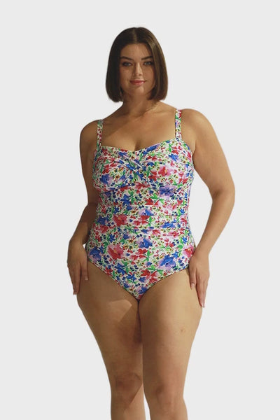 Video of plus size model wearing a strapless bandeau one piece in removable straps in bright floral coloured print