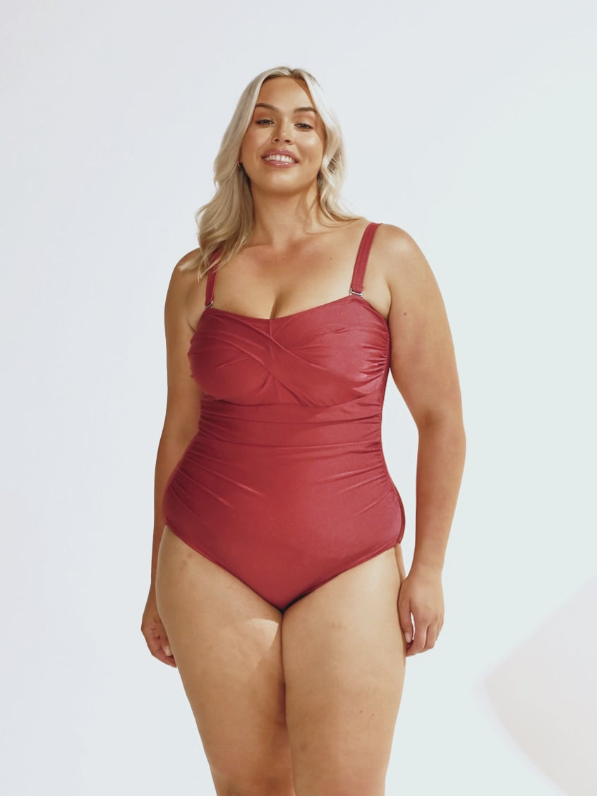 Blonde model in studio wearing a metallic sangria twist front bandeau with removable straps