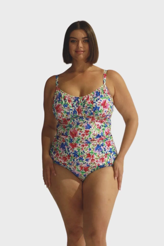 Brunette plus size model wearing bright coloured floral underwire tankini top for curve women