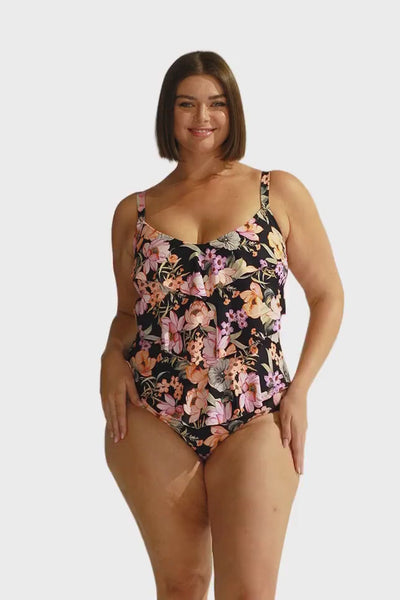 Brunette model wears 3 tier black floral one piece