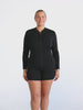 Model in studio wearing a long sleeve chlorine resistant rash vest
