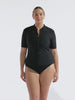 model wearing black short sleeve rash vest with zip