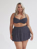 model wearing navy polka dot skater skirt with matching underwire bikini top