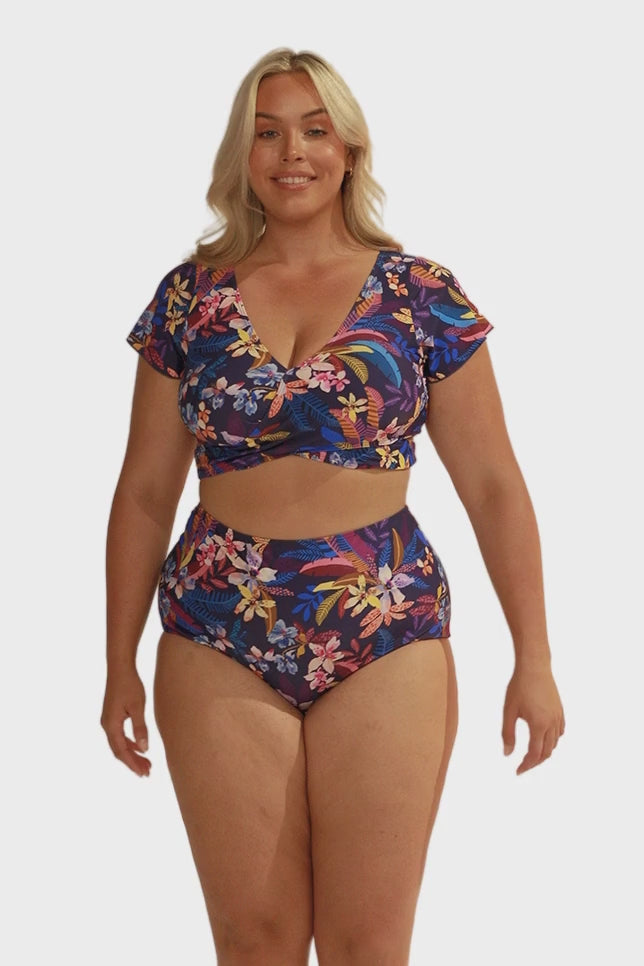 Video of model in studio wearing plus size high waisted pant in floral print