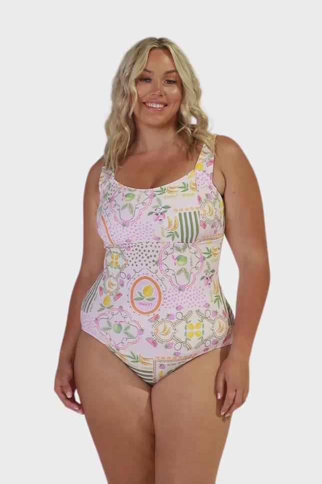 Video of model in studio wearing plus size one piece with square neckline and  tie detail at back