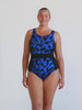Blonde model in studio wearing zip front one piece in chlorine resistant