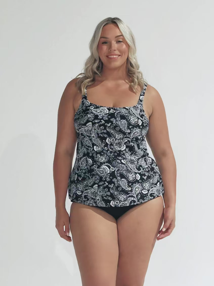 Blonde woman in studio wearing plus size underwire tankini top with paisley black and white print in chlorine resistant