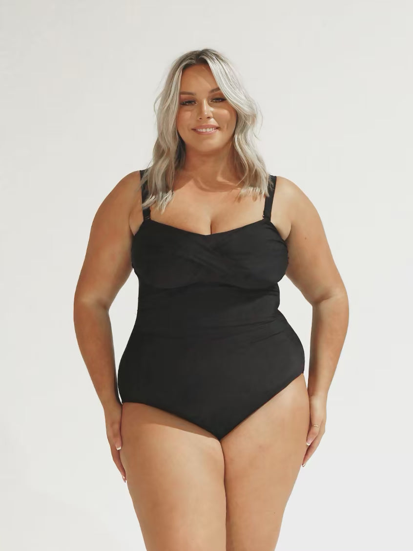 model wearing black curvy twist front bandeau swimsuit