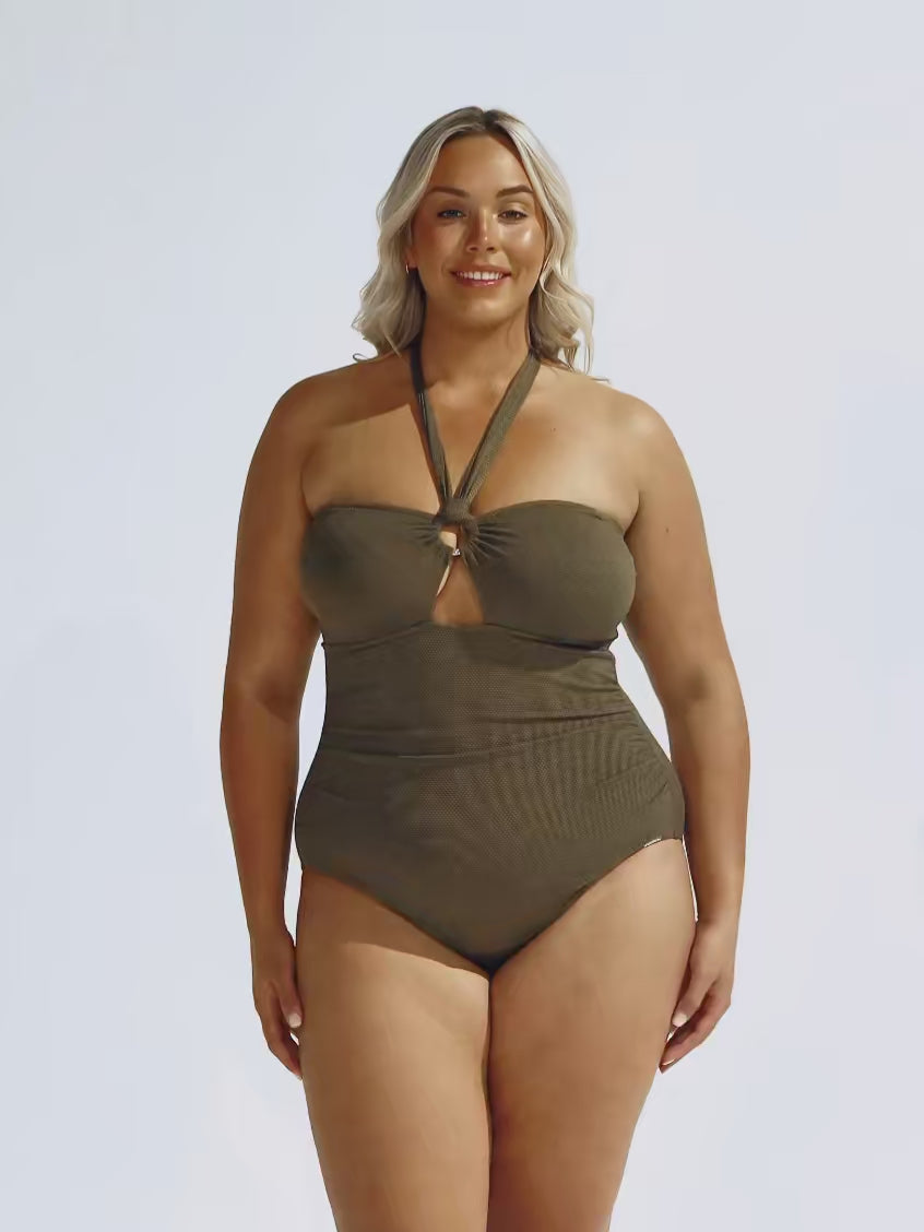 Model in studio wearing plus size one piece with halter tie in kahki textured print