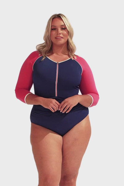 Video of model wearing elbow length sleeve one piece with zip front closure in navy and pink