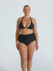 Blonde woman in studio wearing a black halter bikini top 