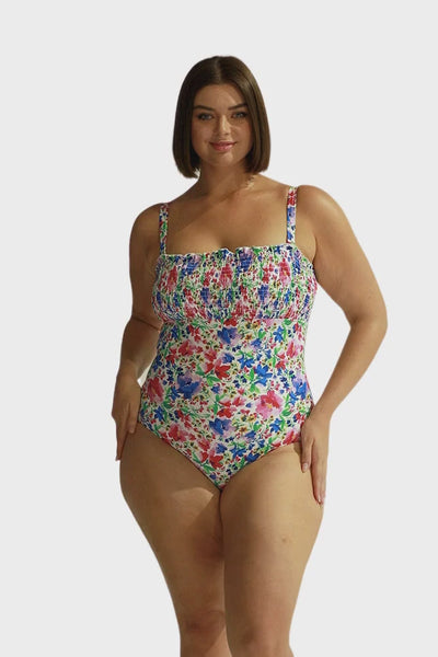 Video of model in studio wearing ruched one piece swimsuit with removable straps for plus size women