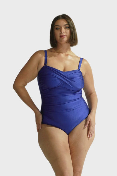 Brunette model wears metallic blue removable straps swimsuit