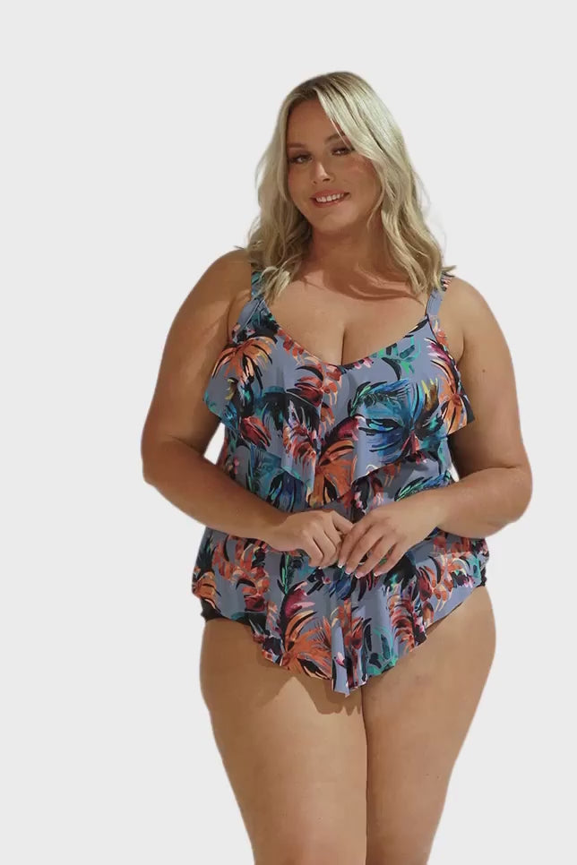 Video of blonde model in studio wearing flattering tiered one piece in blue grey floral print